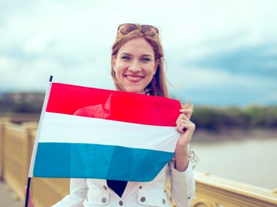 Frau mit niederlandischer Flagge auf einer Brucke hollander oder niederlander Ubersetzungsburo Berlin